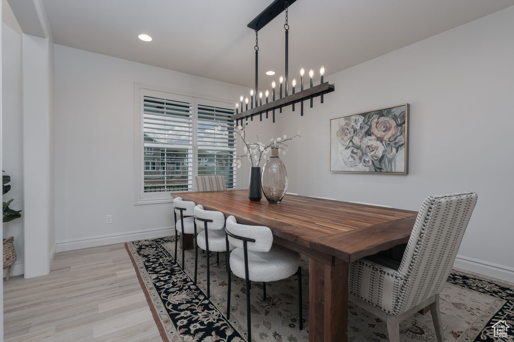Dining area with light wood-type flooring, a chandelier, and recessed lighting