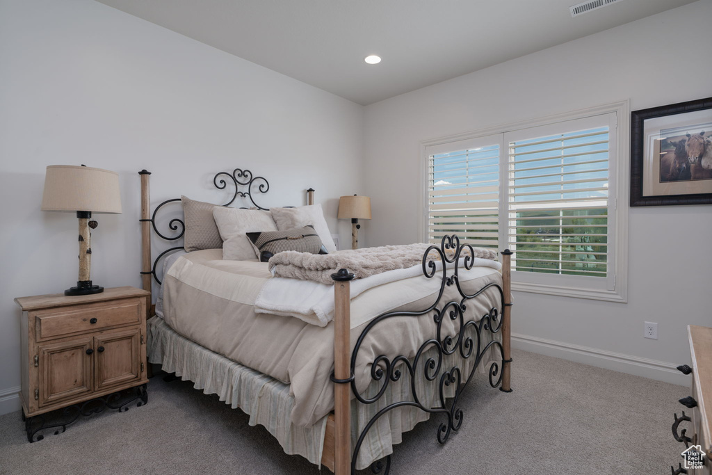 Carpeted bedroom with baseboards and recessed lighting