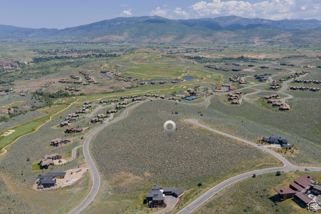 Aerial view of property's location with a mountainous background