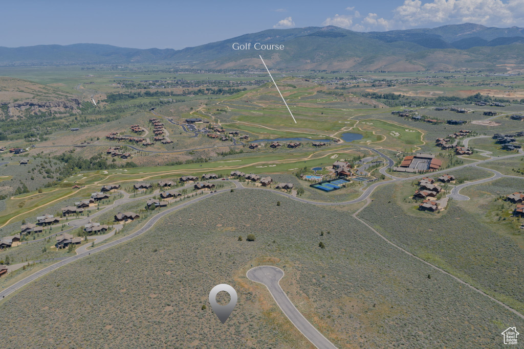 Aerial view of property and surrounding area with a mountainous background
