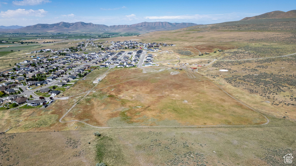 Aerial view of property and surrounding area featuring mountains