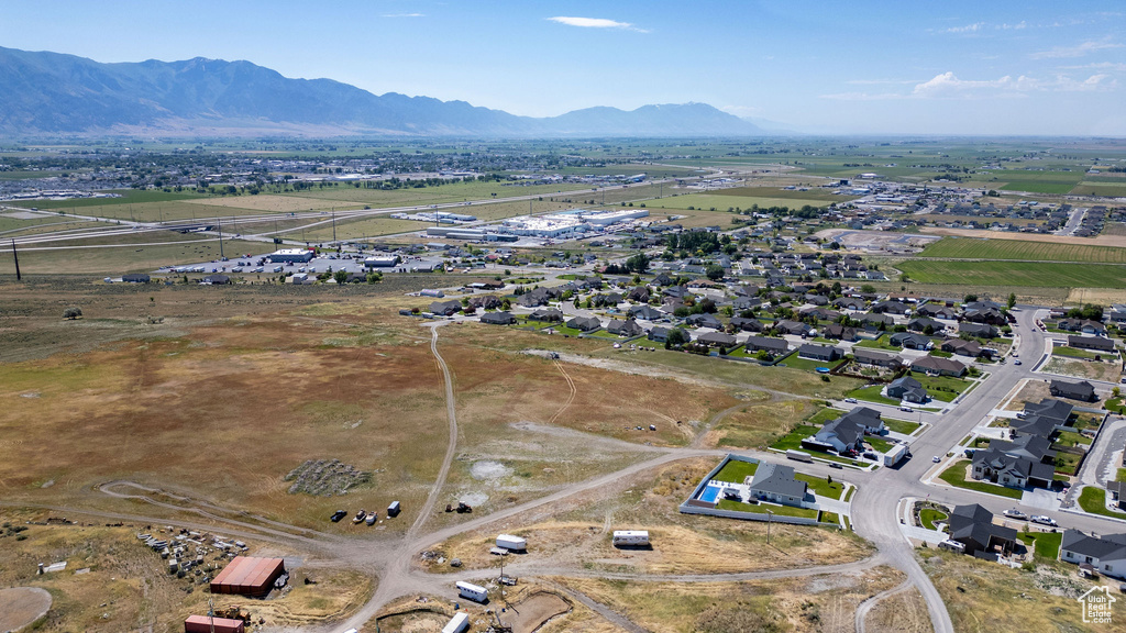 Aerial view of property and surrounding area with a mountain backdrop