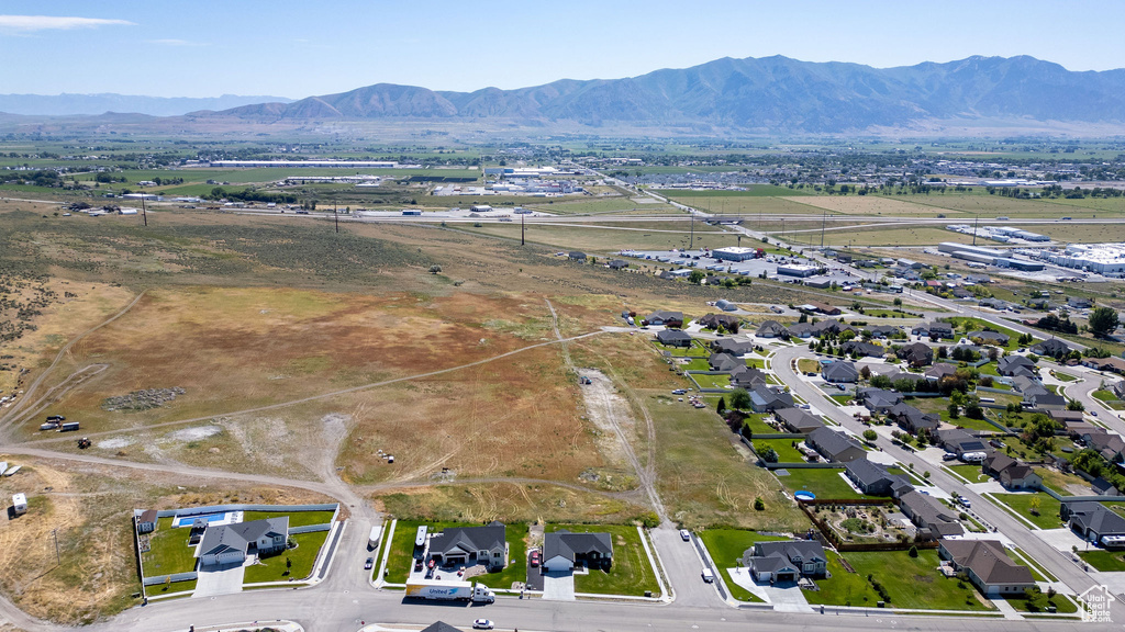 Aerial view of property's location featuring a mountainous background