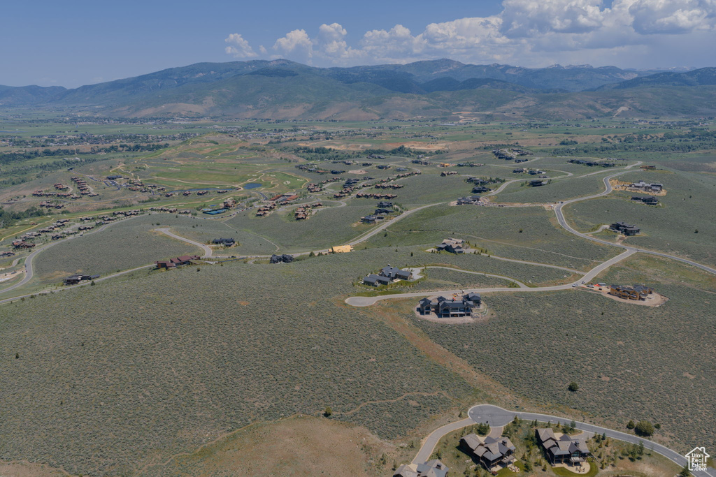 Aerial view of property's location with a mountain backdrop