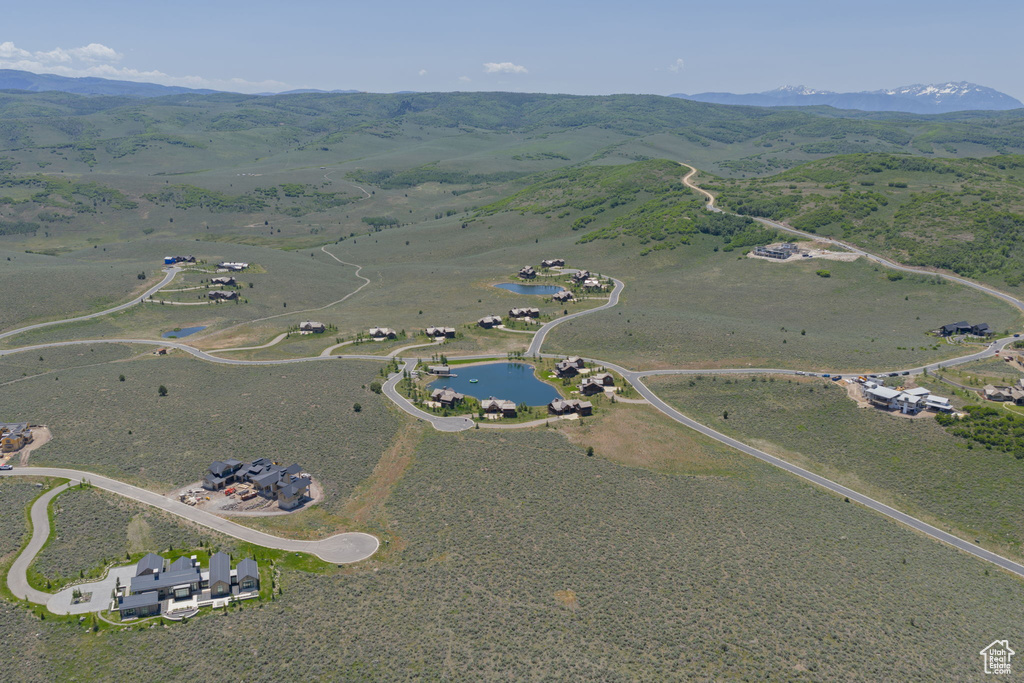 Aerial view of property's location featuring a water and mountain view