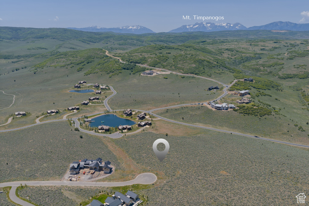 Aerial overview of property's location featuring a water and mountain view