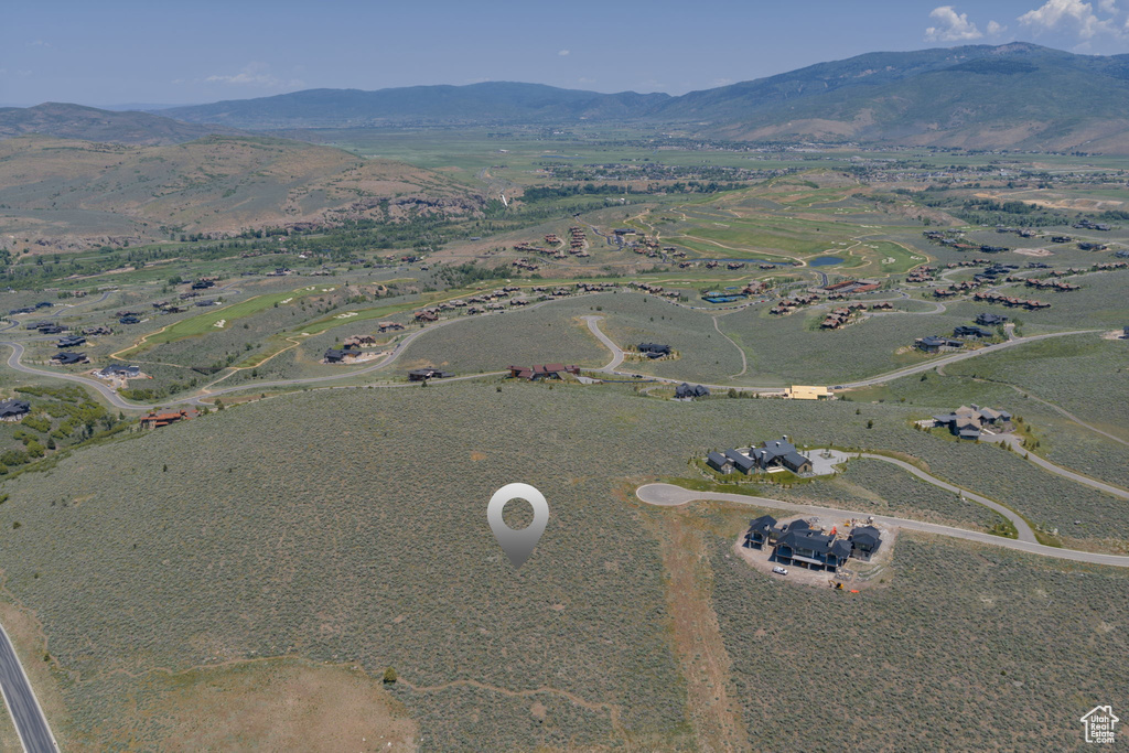 Aerial view of property and surrounding area with mountains