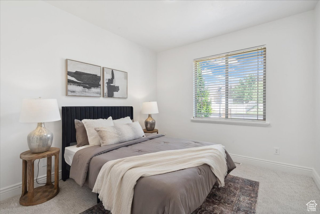 Carpeted bedroom featuring baseboards