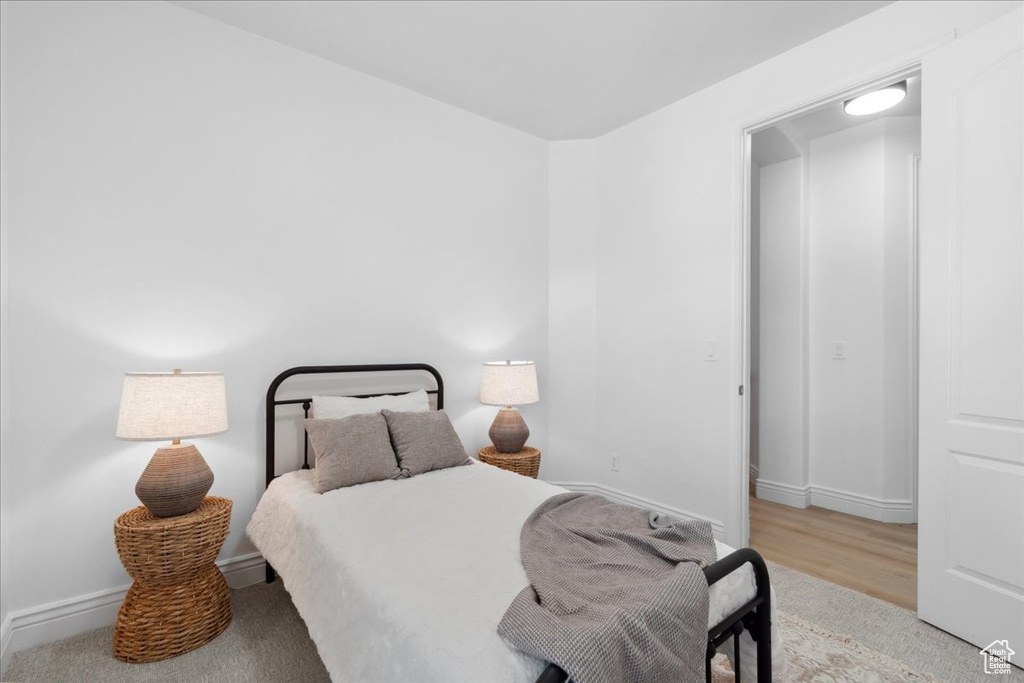 Bedroom with baseboards and wood finished floors