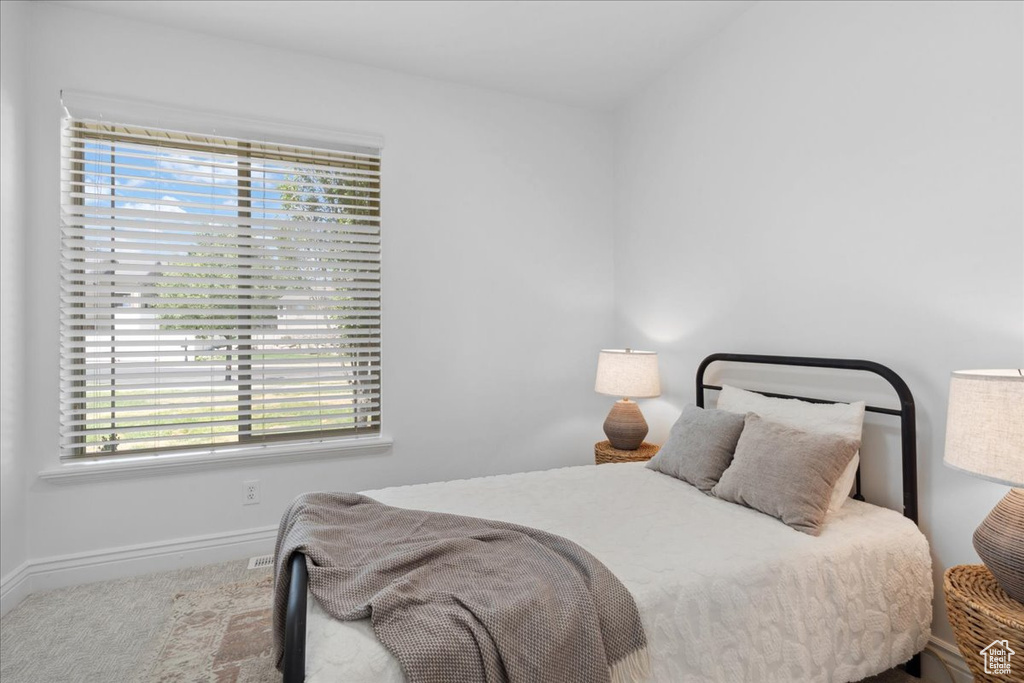 Carpeted bedroom with baseboards