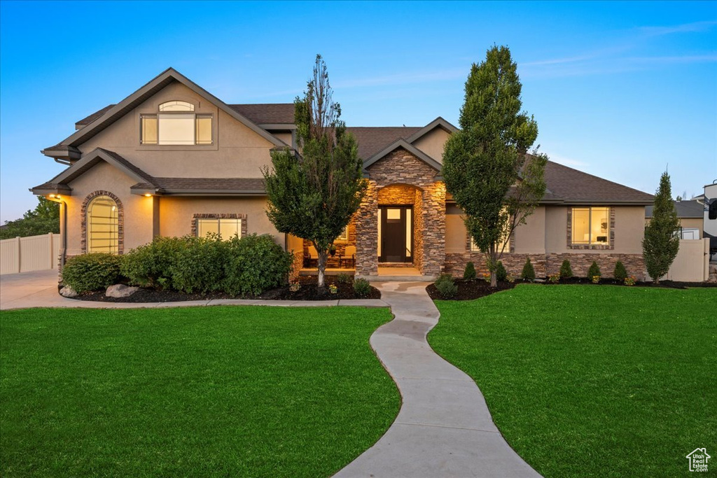 View of front of property featuring stone siding and stucco siding