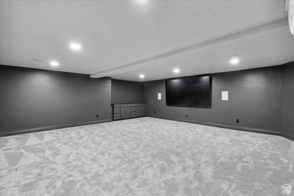 Finished basement with carpet flooring and recessed lighting