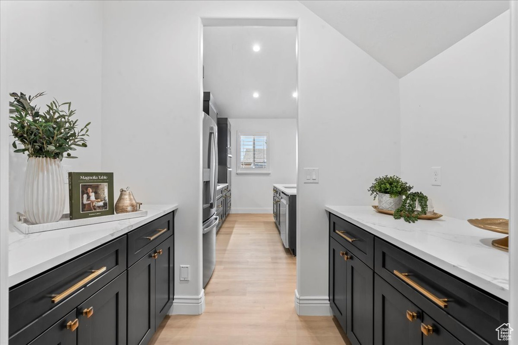Washroom with light wood-style flooring and baseboards