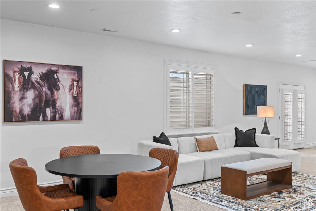 Carpeted living area with recessed lighting and healthy amount of natural light