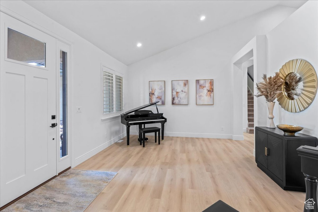 Entrance foyer featuring light wood-style flooring, vaulted ceiling, and recessed lighting