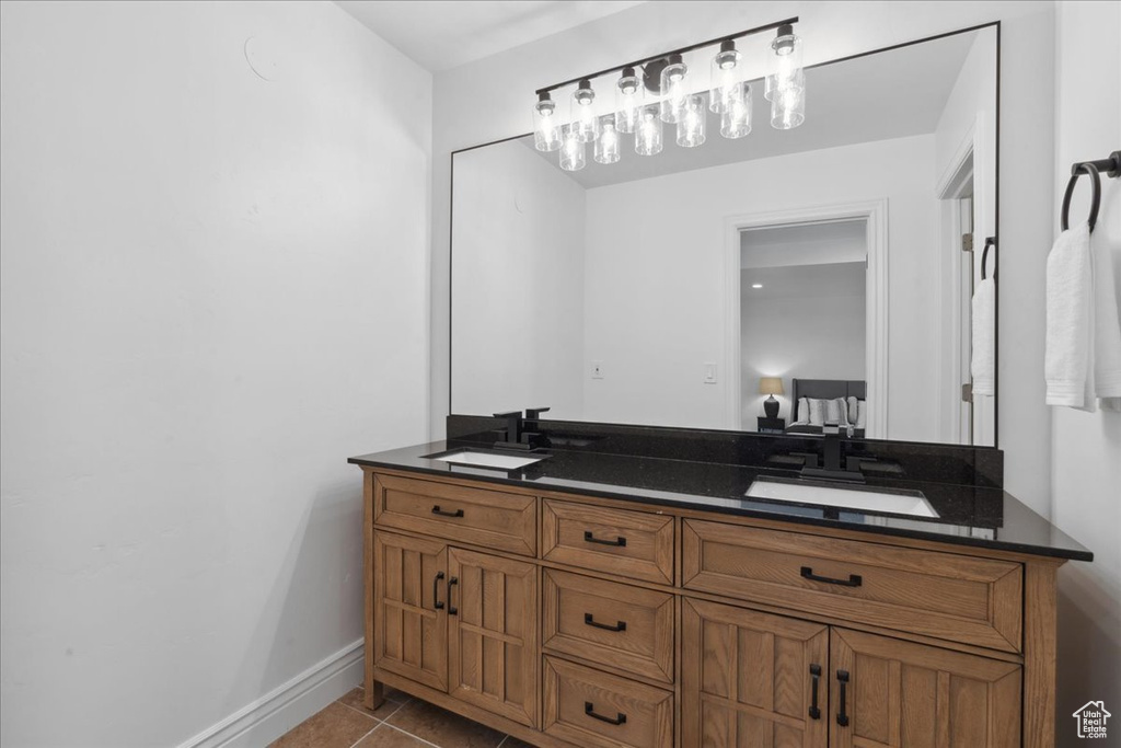 Full bath with double vanity and tile patterned flooring