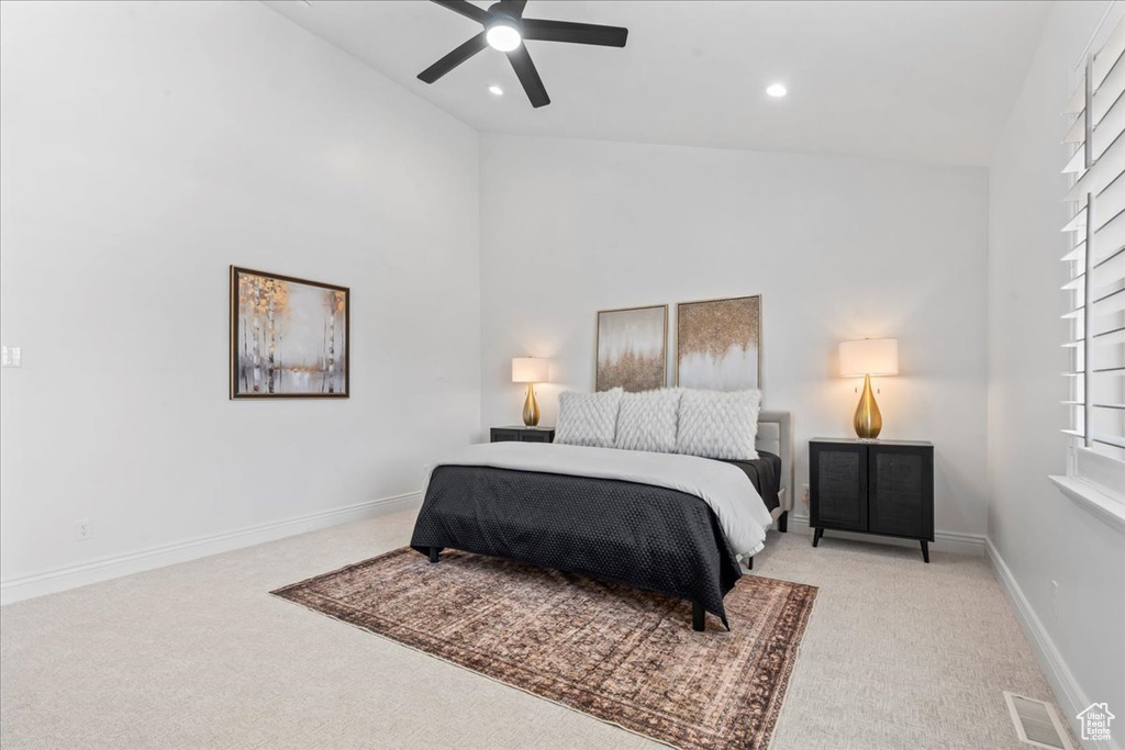 Carpeted bedroom featuring high vaulted ceiling, recessed lighting, and a ceiling fan