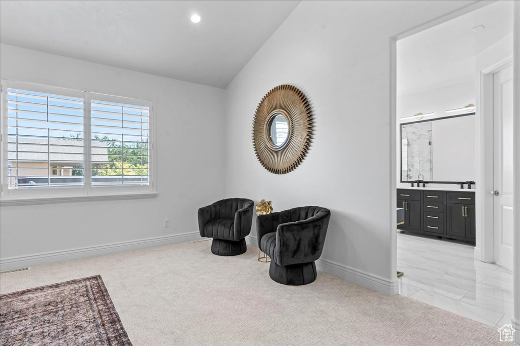 Living area featuring light colored carpet, recessed lighting, and vaulted ceiling