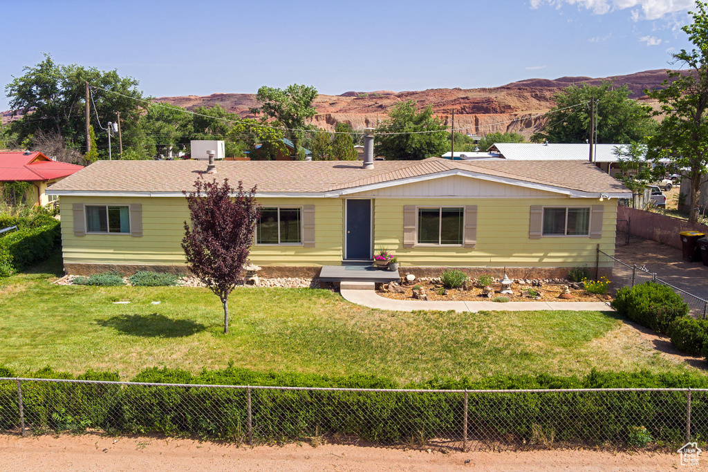 Ranch-style house with a mountain view and a fenced backyard