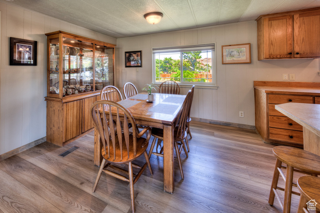 Dining space with light wood-style floors and baseboards