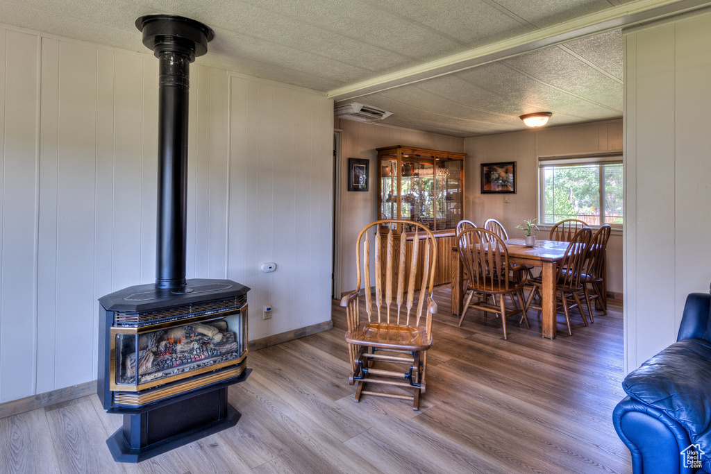 Dining area featuring a wood stove and wood finished floors