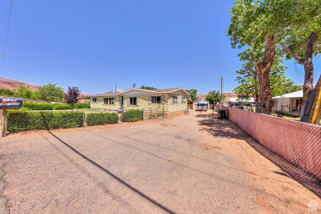 Rear view of property featuring driveway