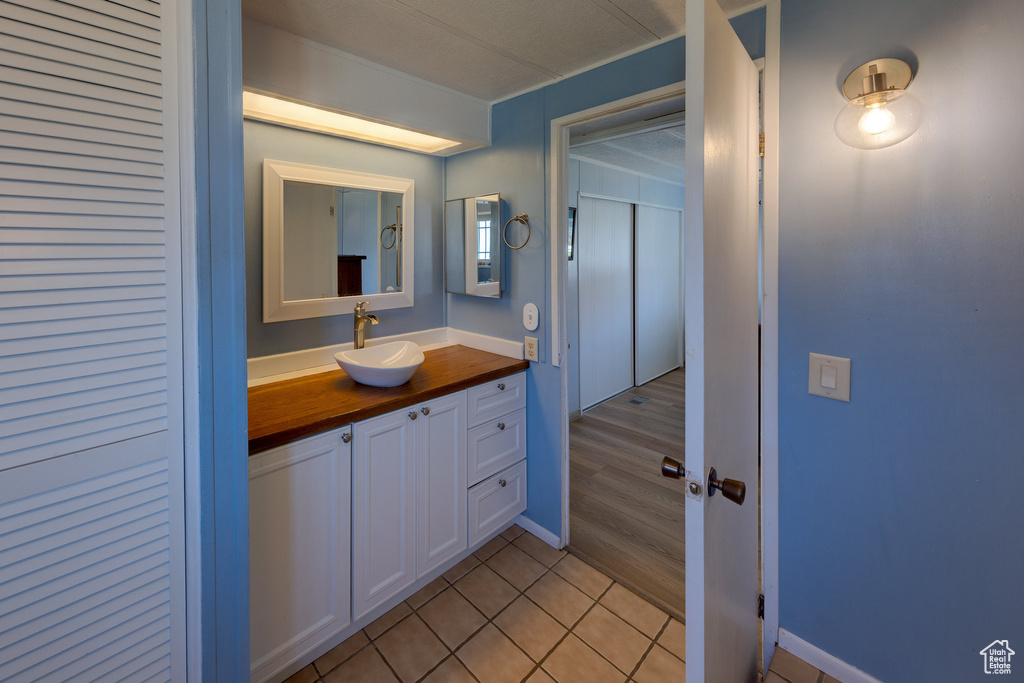 Bathroom featuring tile patterned floors and vanity