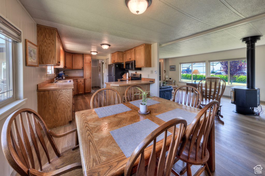 Dining room featuring a wood stove and wood finished floors