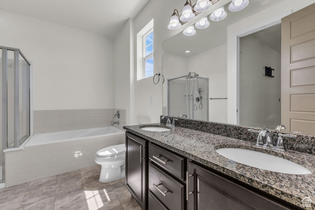 Bathroom with a stall shower, a bath, double vanity, and tile patterned floors