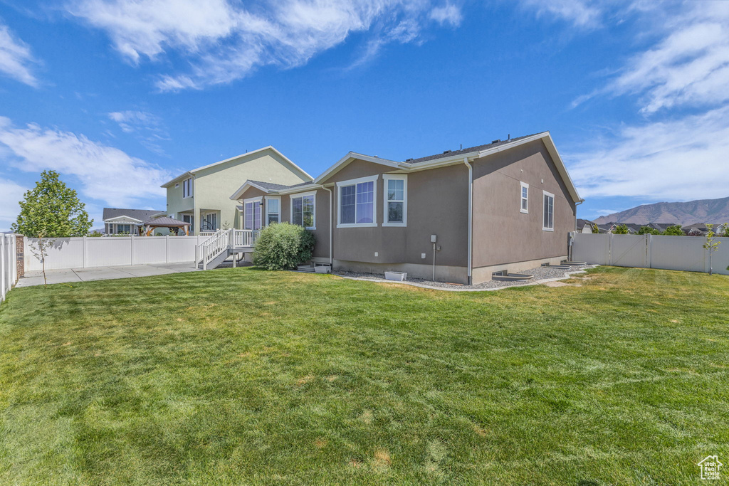 Rear view of property featuring a fenced backyard