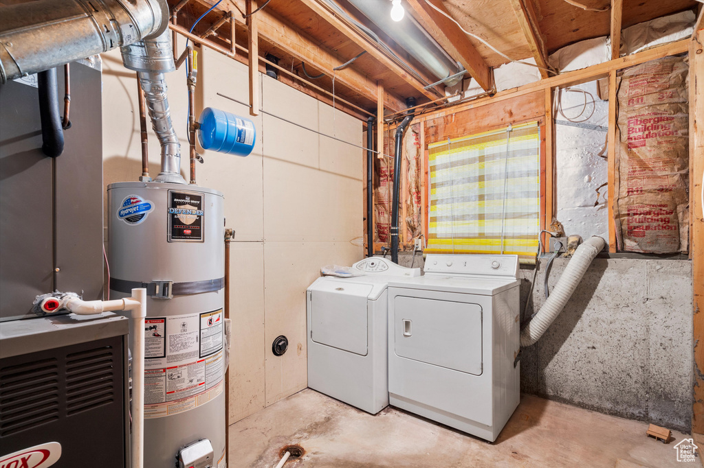 Laundry area featuring gas water heater and independent washer and dryer