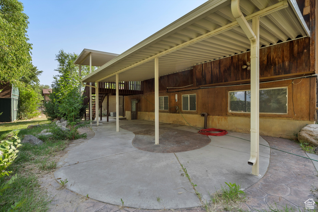 View of patio featuring stairs and a wooden deck