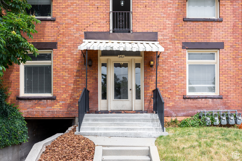 Property entrance featuring brick siding