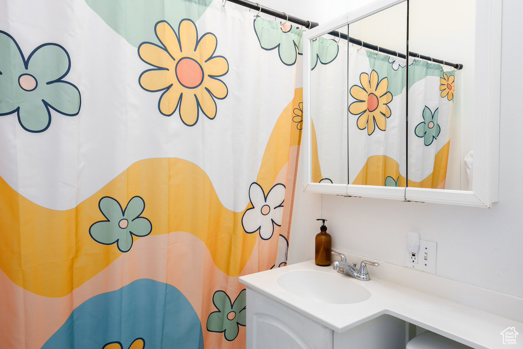 Bathroom with vanity and curtained shower