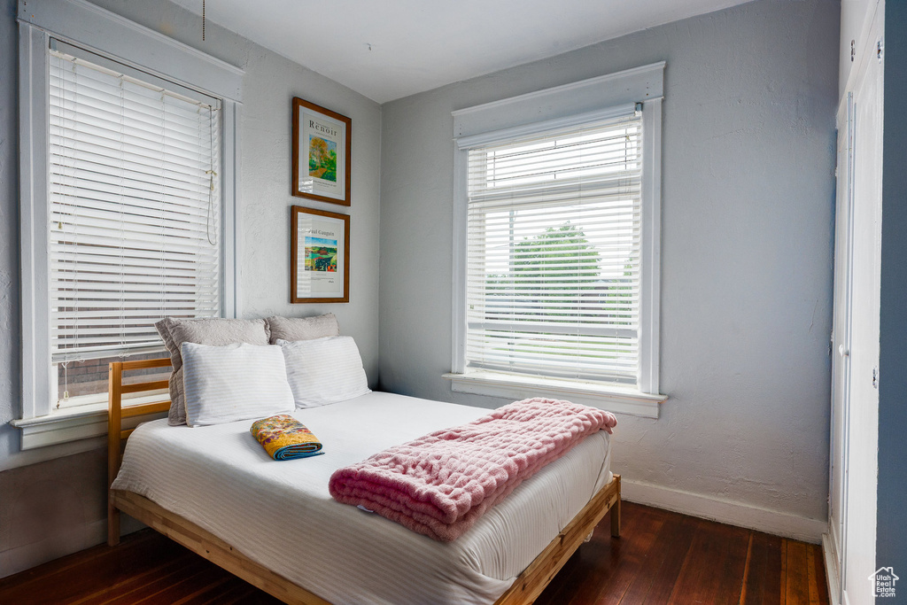 Bedroom featuring wood-type flooring and baseboards