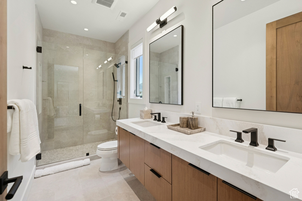 Full bath with double vanity, a shower stall, recessed lighting, and tile patterned floors