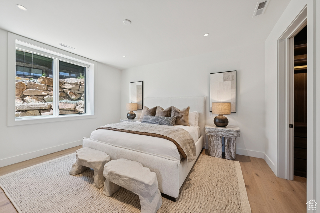 Bedroom with light wood finished floors and recessed lighting