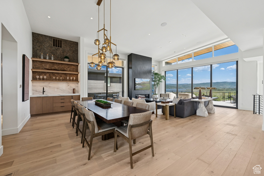 Dining room with light wood-style floors and a chandelier