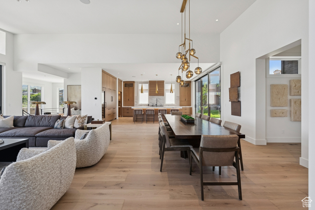 Dining space with light wood-style flooring and recessed lighting