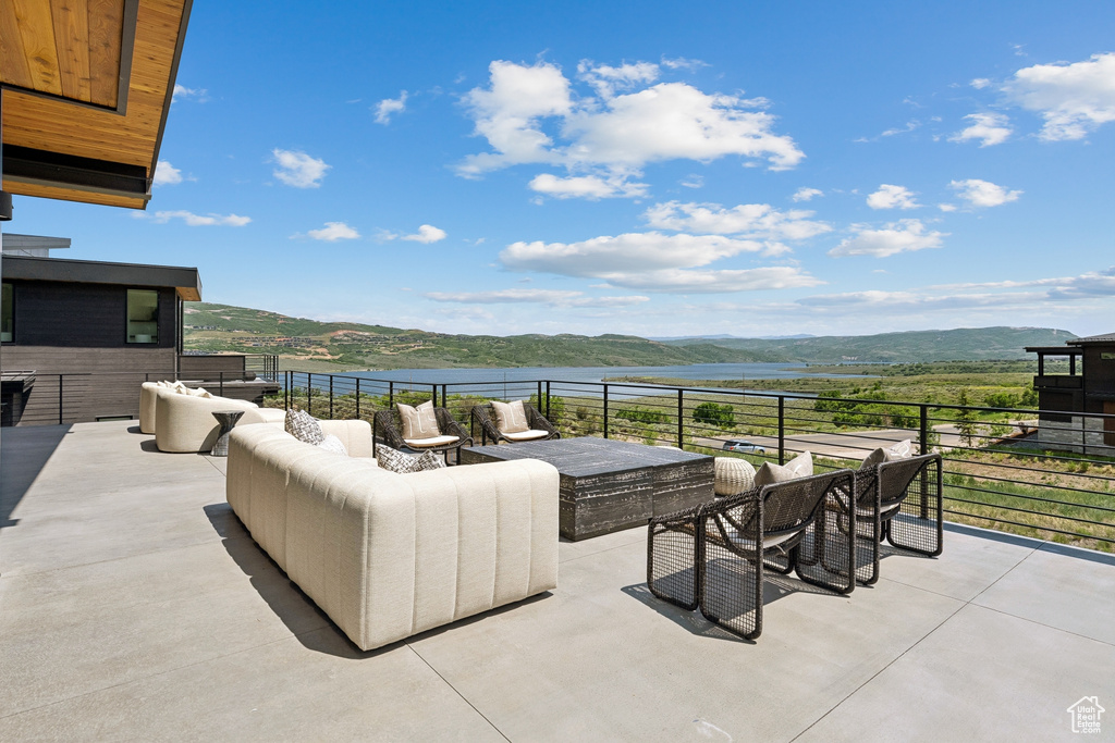 View of patio / terrace with an outdoor living space and a mountain view