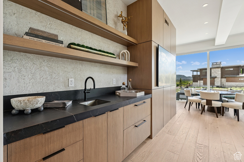 Bar featuring light wood-style floors and recessed lighting