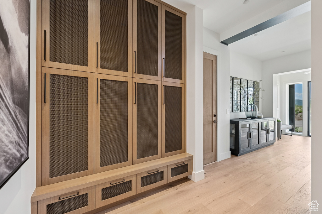 Mudroom with light wood-type flooring and baseboards