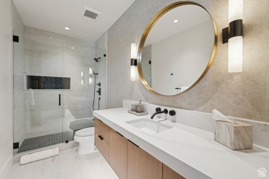 Bathroom featuring vanity, a stall shower, recessed lighting, and tile patterned floors