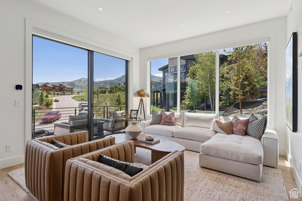 Living area featuring a mountain view, wood finished floors, and recessed lighting