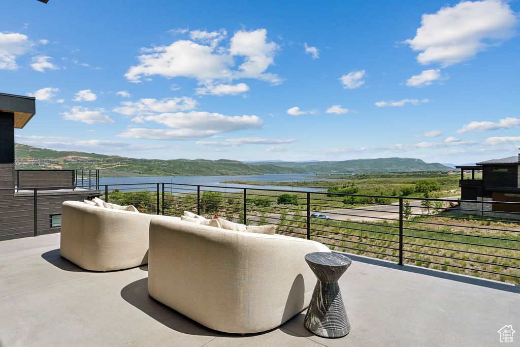Balcony with a water and mountain view