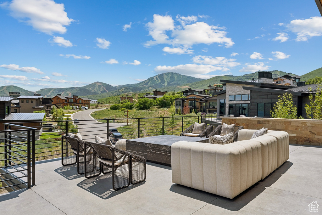 View of patio / terrace featuring an outdoor living space, a mountain view, and a residential view