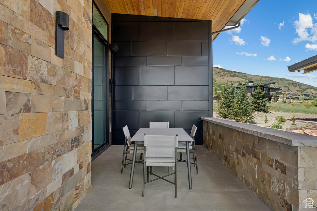 View of patio / terrace featuring outdoor dining space and a mountain view