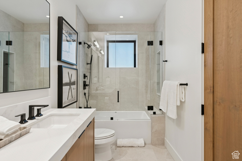 Full bath with vanity and combined bath / shower with glass door