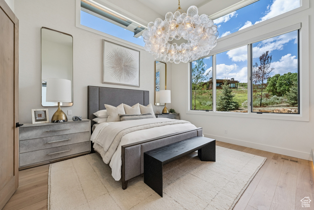 Bedroom featuring a chandelier and wood finished floors