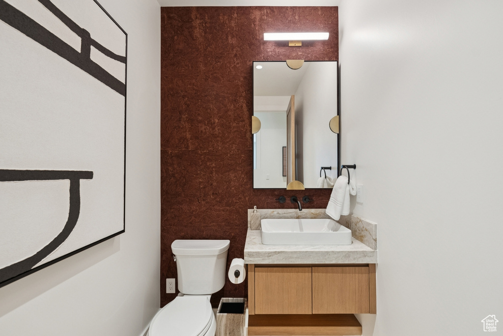 Half bath featuring vanity and toilet